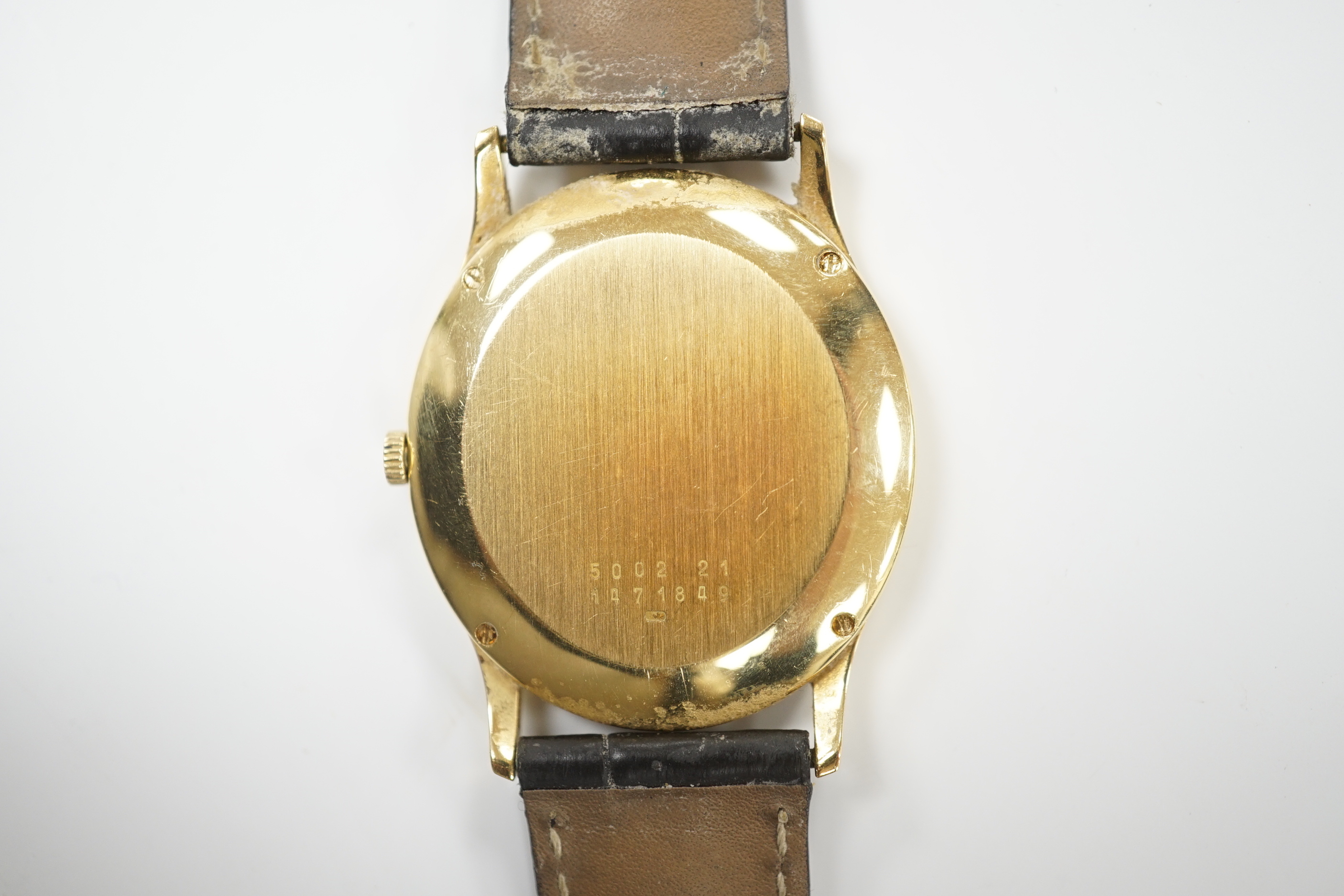 A gentleman's 18k Jaeger LeCoultre automatic dress wrist watch, with oval Roman dial and date aperture, on a leather strap with gold plated Jaeger buckle, case diameter 31mm, no box or papers.